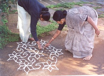 Mother Teaches Kolam to Daughter